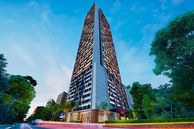 a tall building with a pointed top on a street at Scarletz suites klcc Bukit Bintang by lulu in Kuala Lumpur
