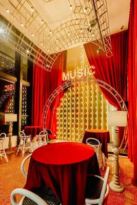 a room with red curtains and a red table and chairs at Scarletz suites klcc Bukit Bintang by lulu in Kuala Lumpur