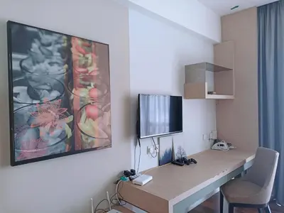 a room with a desk with a tv on a wall at D'Majestic Place, 1 King or 2 Super Single beds in Kuala Lumpur
