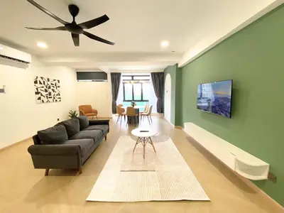 a living room with a couch and a ceiling fan at KAĨTE Homestay at Fahrenheit88 Bukit Bintang in Kuala Lumpur