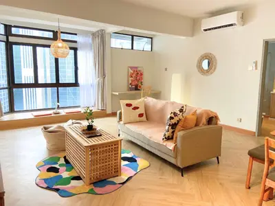 a living room with a couch and a table at KAĨTE Homestay at Fahrenheit88 Bukit Bintang in Kuala Lumpur