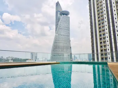 a swimming pool with a building in the background at KL Gateway Residences in Kuala Lumpur