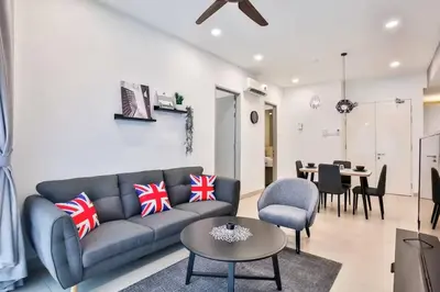 a living room with a couch and a table at KL Gateway Residences in Kuala Lumpur