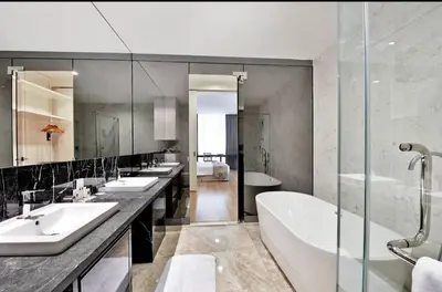 a bathroom with three sinks and a bath tub at The Platinum Kuala Lumpur KLCC By Garden Suites in Kuala Lumpur