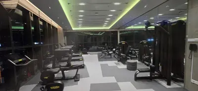 a gym with rows of exercise equipment in a room at Imperial Suites KLCC in Kuala Lumpur