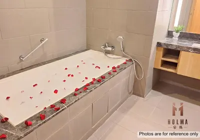 a bath tub with red roses on it in a bathroom at 188 Suites KLCC by Holma in Kuala Lumpur