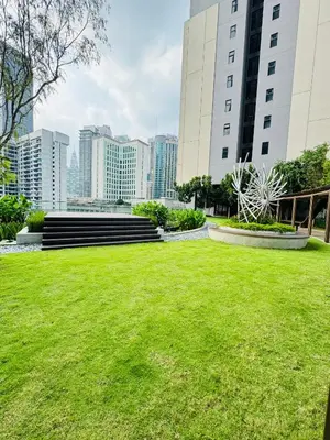 a park with green grass and buildings in the background at Axon Suite Premium KL in Kuala Lumpur