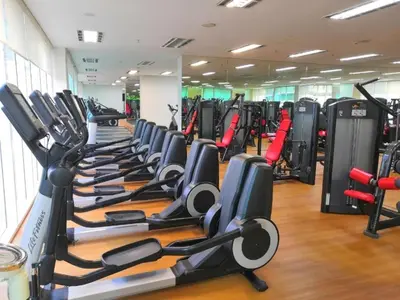 a gym with a row of treadmills and machines at 2bedroom SOHO SUITE KLCC View by Homeizing in Kuala Lumpur