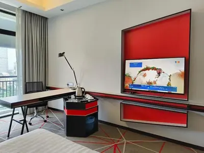 a room with a desk and a large tv on the wall at Suites at Maison 101,Heart Of KL City in Kuala Lumpur