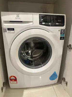 a washing machine sitting in a room at Chambers A Studio Flat, KLCC & KL Tower ,view in City in Kuala Lumpur
