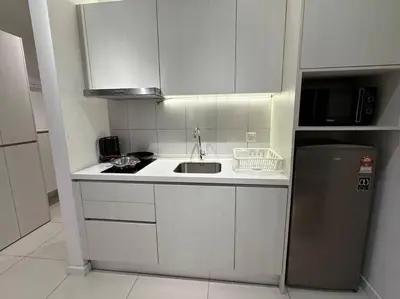 a small kitchen with a sink and a refrigerator at Chambers A Studio Flat, KLCC & KL Tower ,view in City in Kuala Lumpur