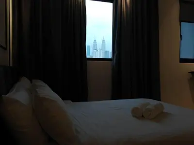a bedroom with a bed with two towels on it at Chambers A Studio Flat, KLCC & KL Tower ,view in City in Kuala Lumpur