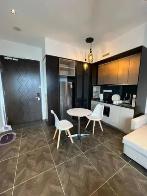 a living room with a table and chairs and a kitchen at Borderless Swimming Pool - Invincible Twin Towers View - Free WiFi in Kampong Gombak Utara