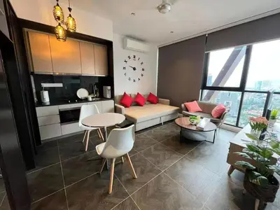 a living room with a couch and a table at Borderless Swimming Pool - Invincible Twin Towers View - Free WiFi in Kampong Gombak Utara