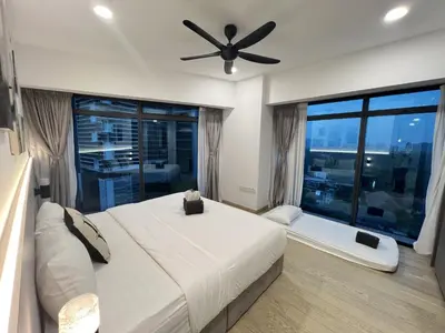 a bedroom with a large bed and a ceiling fan at Eaton Residence KLCC By HM Costa Doro in Kuala Lumpur
