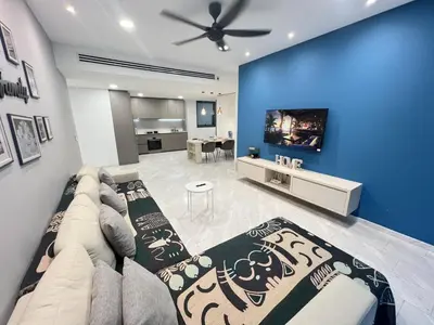 a living room with a couch and a flat screen tv at Eaton Residence KLCC By HM Costa Doro in Kuala Lumpur