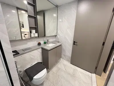 a bathroom with a toilet and a sink and a mirror at Eaton Residence KLCC By HM Costa Doro in Kuala Lumpur