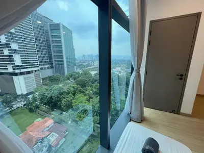 a room with a window with a view of a city at Eaton Residence KLCC By HM Costa Doro in Kuala Lumpur