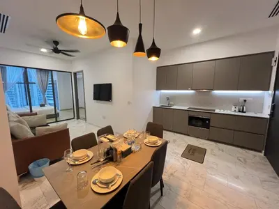 a dining room and kitchen with a table and chairs at Eaton Residence KLCC By HM Costa Doro in Kuala Lumpur