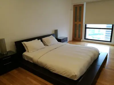 a large bed in a room with a window at KL Apartment At Berjaya Times Square in Kuala Lumpur