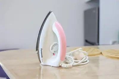 a white and pink telephone sitting on a table at Urban KL Gem Perfect Getaway High Speed 100Mbps in Kuala Lumpur