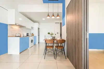 a kitchen and dining room with a table and chairs at Exquisite KL Retreat Pool & Gym High Speed 100MB in Kuala Lumpur
