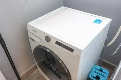 a white washing machine sitting in a room at Conveniently Located Trion KL Premium Amenities in Kuala Lumpur