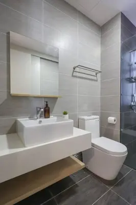 a bathroom with a white sink and a toilet at Conveniently Located Trion KL Premium Amenities in Kuala Lumpur