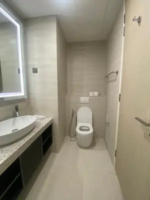 a bathroom with a white toilet and a sink at Eastern Suites Star KLcc in Kuala Lumpur