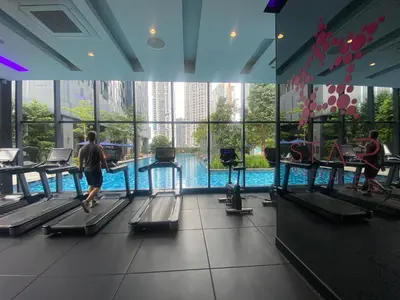 a group of people walking around a swimming pool at Eastern Suites Star KLcc in Kuala Lumpur