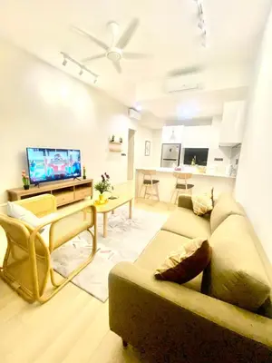a living room with a couch and a flat screen tv at Eastern Suites Star KLcc in Kuala Lumpur
