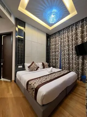 a bedroom with a large bed with a blue ceiling at The Dorsett Residence Service Suite Bukit Bintang KL in Kuala Lumpur