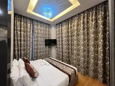 a bedroom with a bed and a ceiling at The Dorsett Residence Service Suite Bukit Bintang KL in Kuala Lumpur