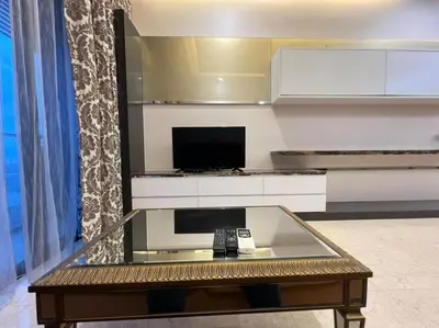 a living room with a glass table with a remote control at The Dorsett Residence Service Suite Bukit Bintang KL in Kuala Lumpur