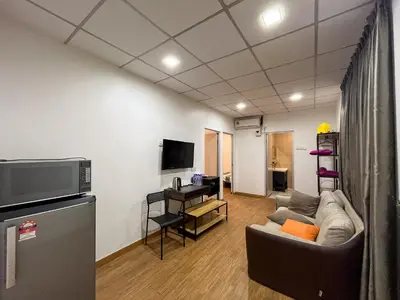 a living room with a couch and a tv at Titiwangsa Cabin Retreats by uBook in Kuala Lumpur