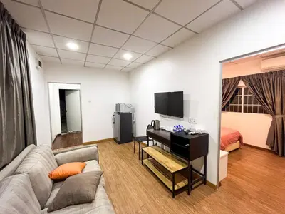 a living room with a couch and a television at Titiwangsa Cabin Retreats by uBook in Kuala Lumpur