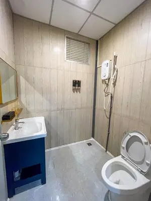 a bathroom with a toilet and a sink at Titiwangsa Cabin Retreats by uBook in Kuala Lumpur