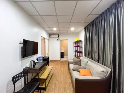a living room with a couch and a tv at Titiwangsa Cabin Retreats by uBook in Kuala Lumpur