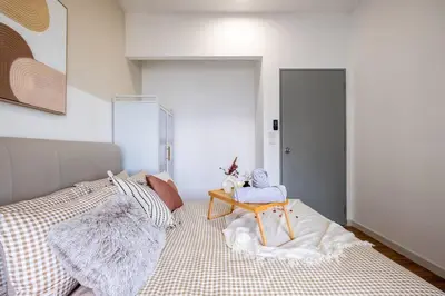 a bedroom with a bed with a table on it at M Vertica KL City Tower C By Feel Home in Kuala Lumpur