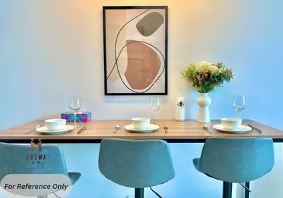 a wooden table with chairs and a table with a picture at The Colony BEST SKY Pool View in Kuala Lumpur