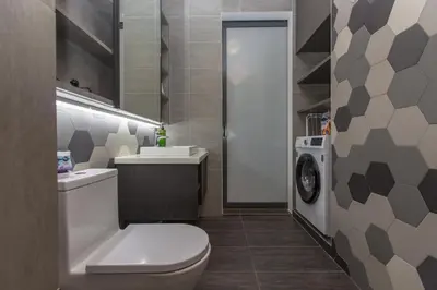 a bathroom with a toilet and a sink and a washing machine at Ceylonz Suites near KLCC& KL Tower by My Trip & My Stay in Kuala Lumpur