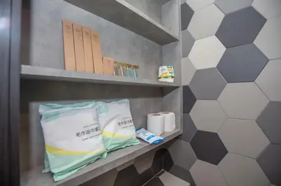 a shelf in a bathroom with toilet paper and towels at Ceylonz Suites near KLCC& KL Tower by My Trip & My Stay in Kuala Lumpur