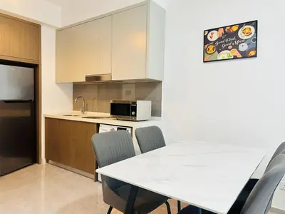 a kitchen with a table and chairs and a microwave at Agile Bukit Bintang Suites TRX in Kuala Lumpur