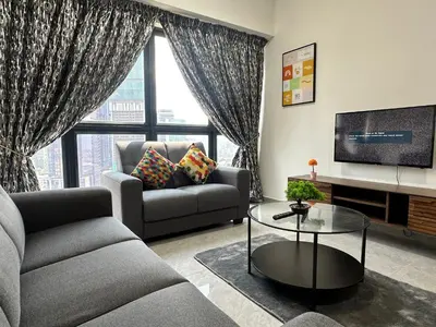 a living room with a couch and a tv at Agile Bukit Bintang Suites TRX in Kuala Lumpur