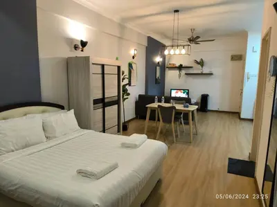 a bedroom with a bed and a living room with a table at 19-16 Casa Mutiara-Sweet Home city view in Kuala Lumpur
