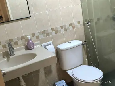 a bathroom with a white toilet and a sink at 19-16 Casa Mutiara-Sweet Home city view in Kuala Lumpur