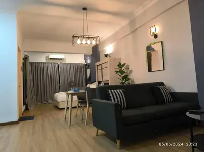 a living room with a couch and a table at 19-16 Casa Mutiara-Sweet Home city view in Kuala Lumpur