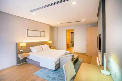 a hotel room with a bed and a desk and a tv at 188 Suites KLCC by Premium Suites in Kuala Lumpur