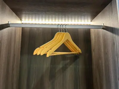 a bunch of wooden utensils are hanging from a shelf at Chambers Residence by Manhattan Group in Kuala Lumpur