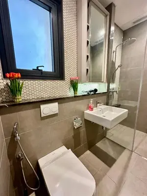 a bathroom with a toilet and a sink and a window at Luxurious Home Smart service Lucentia residence in Kuala Lumpur